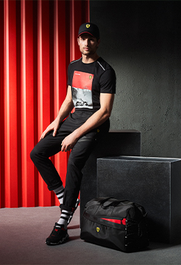 A seated whole-body man wears a white, red and black Air Intake Bomber.