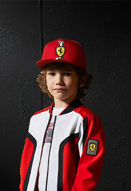 A three-quarter half-body boy wears white, red and black Infinity bomber jacket.
