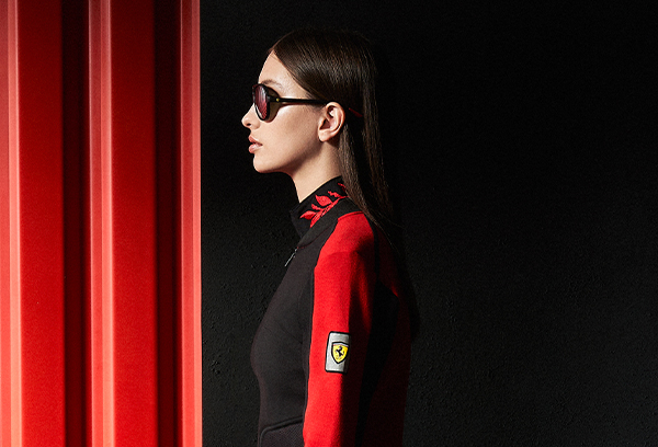 A half-body woman wears black and red Infinity sweatshirt.