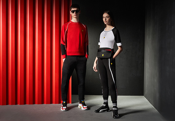 FOUR MODELS, TWO MEN AND TWO WOMEN, WEAR SCUDERIA FERRARI'S CLOTHES AND ACCESSORIES.