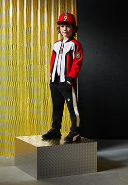 A whole-body boy wearing Scuderia Ferrari Mini-me clothes and accessories.