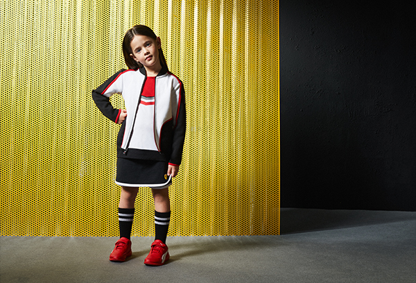 A whole-body girl wearing Scuderia Ferrari Mini-me clothes and accessories.