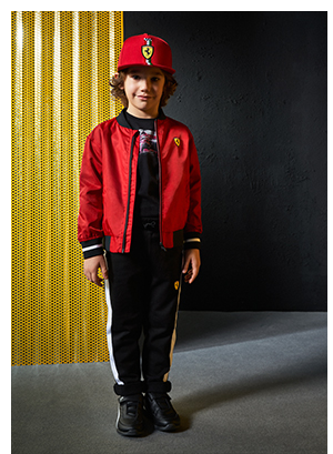 A boy wearing Scuderia Ferrari Collection's clothes and accessories