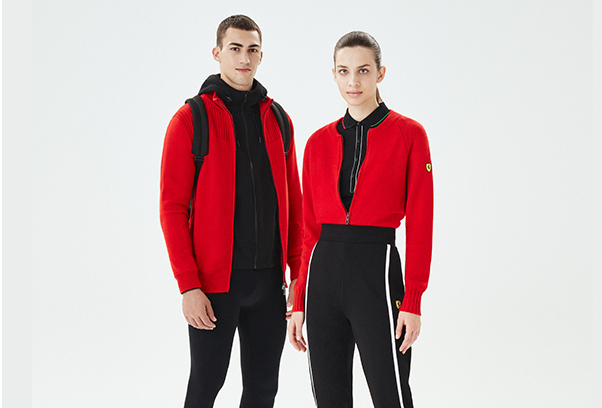 A WOMAN AND A MAN WEARING RED AND BLACK SCUDERIA FERRARI CLOTHES AND ACCESSORIES