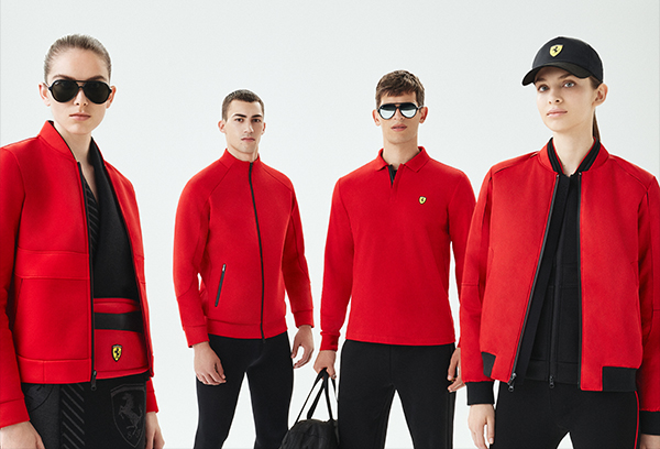 Two men and one woman wearing Scuderia Ferrari clothes and accessories.