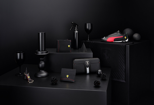BLACK SHOES AND ACCESSORIES ON GEOMETRIC BLACK BACKGROUND.