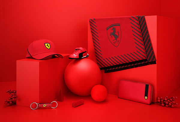Red and black accessories on a red background with geometric blocks.