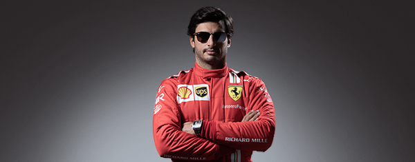 Half-length picture of Carlos Sainz with his arms folded wearing Ray-Ban for Scuderia Ferrari.