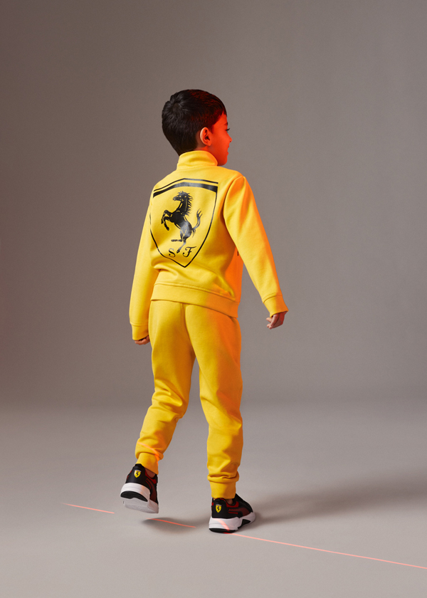 Full-length picture of a boy wearing yellow Supima Cotton Sweatshirt and joggers