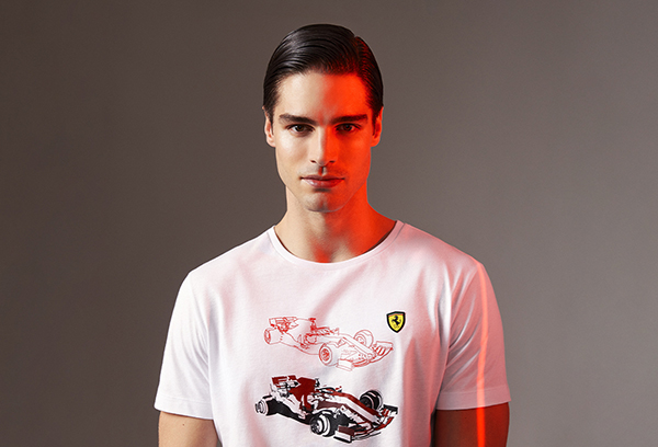Half-length picture of a man wearing white jersey T-shirt with Formula 1 single-seater print.