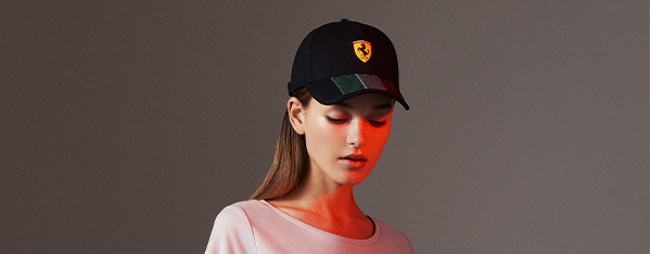 Half-length picture of a woman wearing Ferrari clothes and accessories.