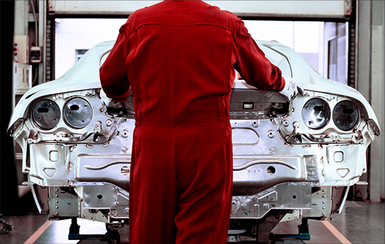 A man working on a Vehicle Under Construction inside Maranello Car Factory