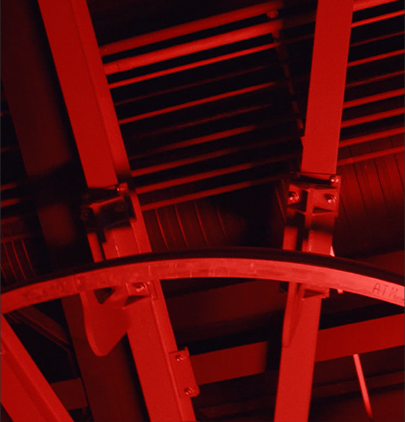 A close-up picture of details of Maranello Car Factory in a red light