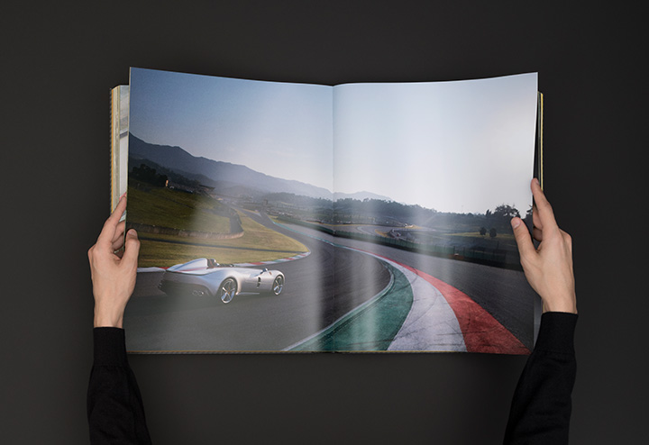 A picture of hands browsing Ferrari Monza Book