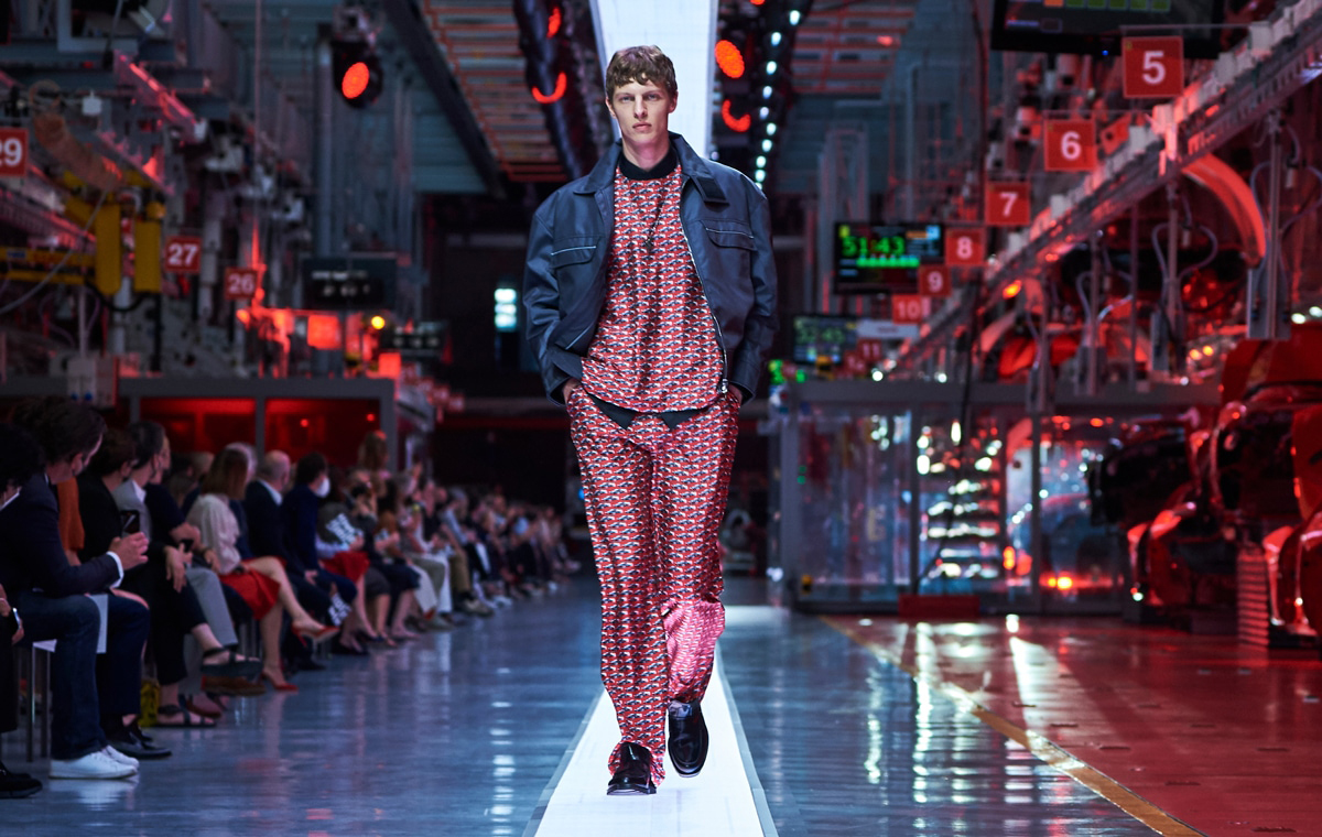 Full-length picture of a man walking the catwalk during the fashion show wearing all-over printed top and trousers