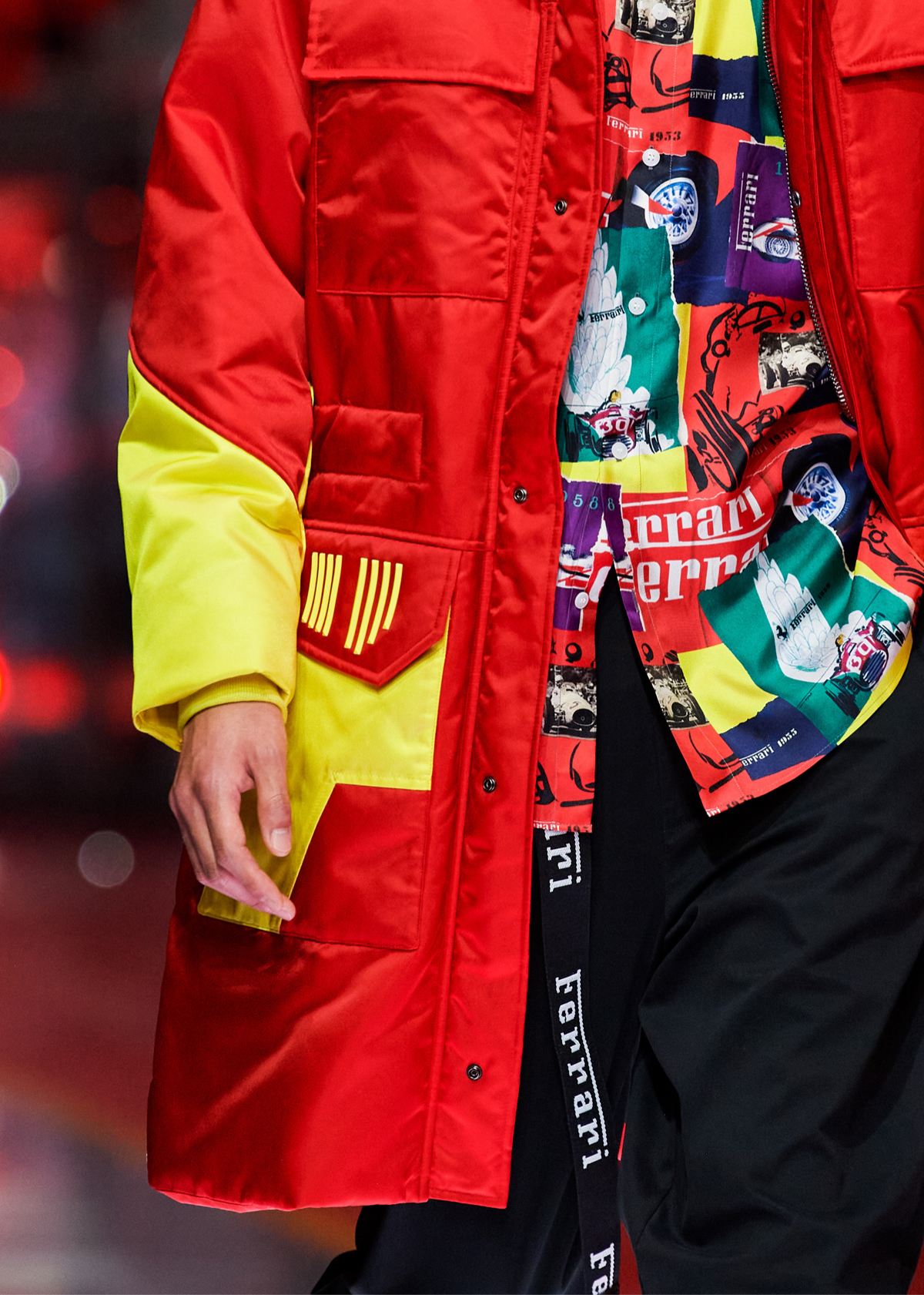 Detail on model wearing a red parka and a patterned shirt