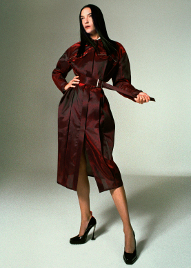 Woman wearing iridescent red nylon trench coat
