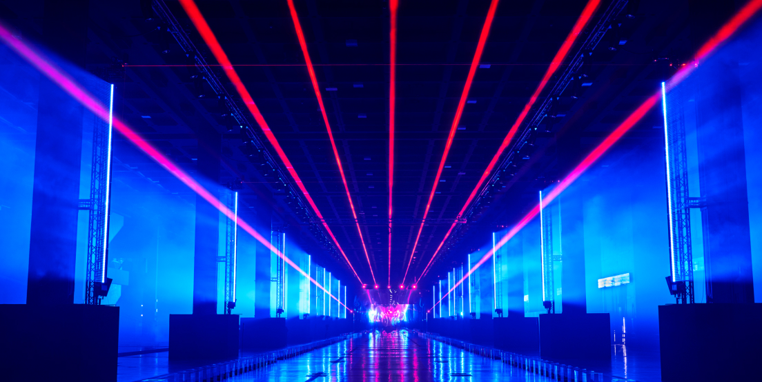Shot from the front of the empty catwalk with blue lights and red neon lights
