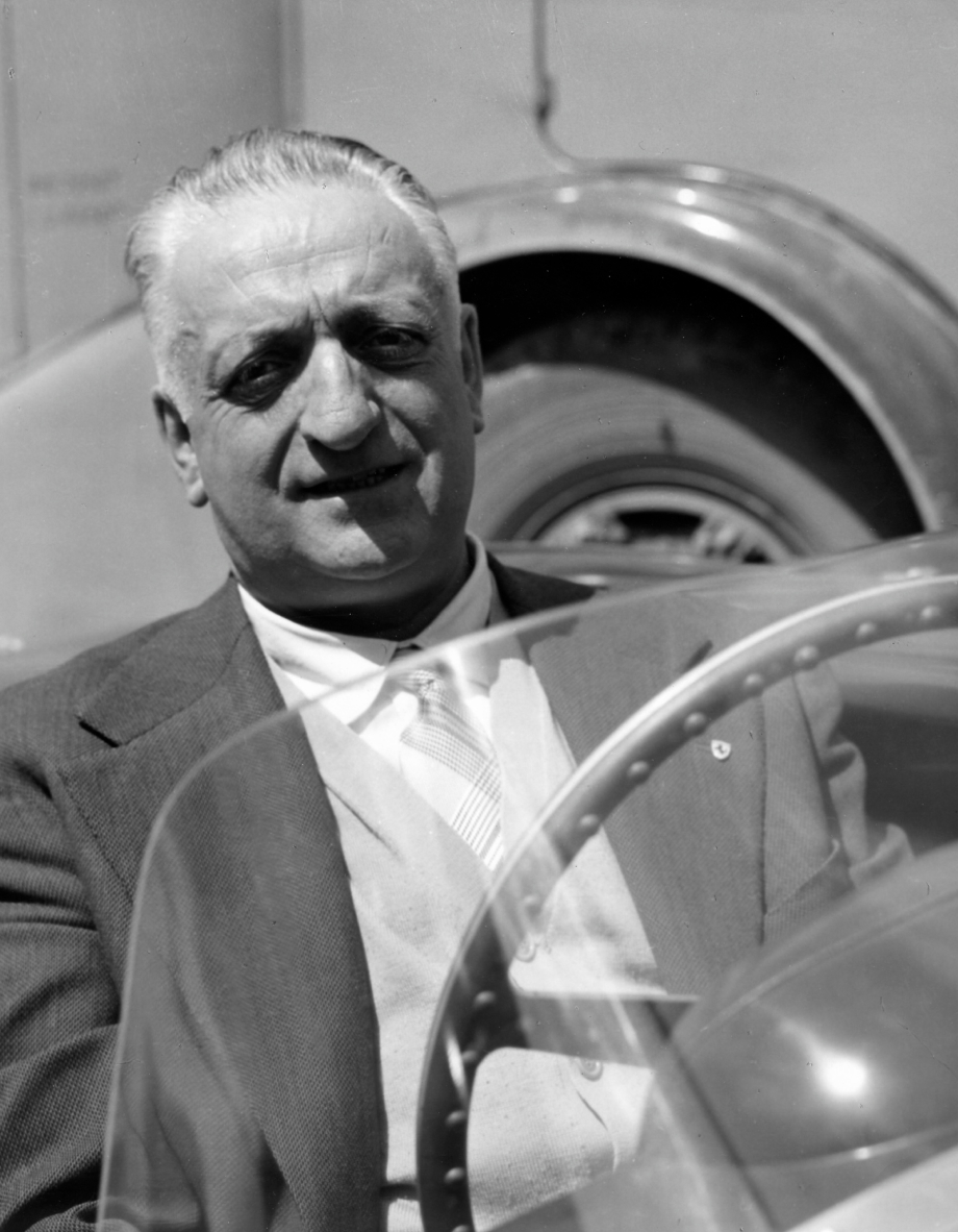 An image of Enzo Ferrari behind the steering wheel