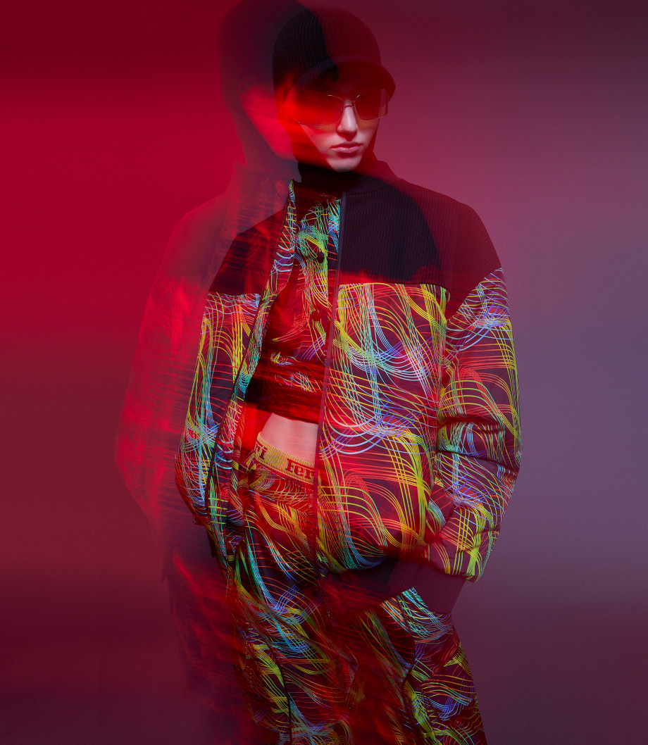 Front view of a person wearing bomber jacket and trousers with speed form print. The shot is in motion.
