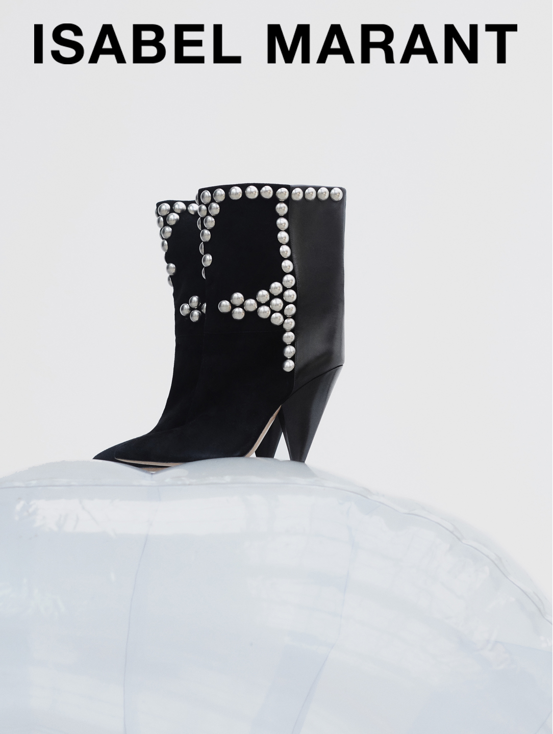 THE LAYO BOOTS IN BLACK WITH SILVER STUDS ON A INFLATABLE COUCH